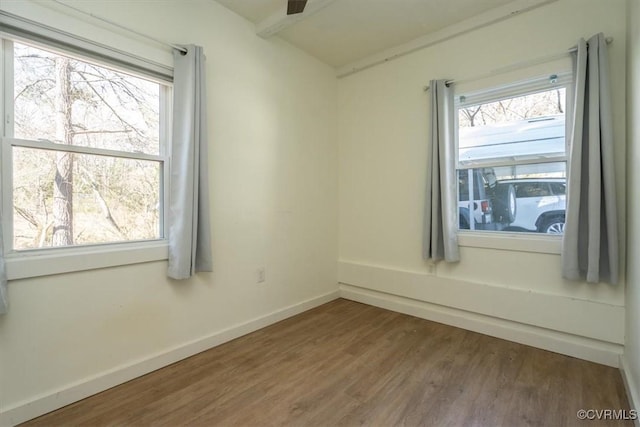 unfurnished room featuring a wealth of natural light and hardwood / wood-style flooring