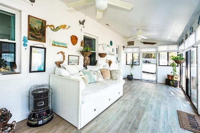 sunroom / solarium featuring lofted ceiling and ceiling fan