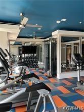 exercise room featuring dark colored carpet