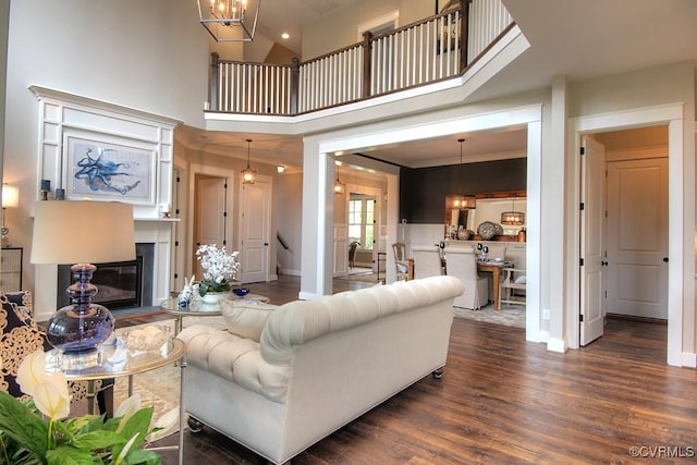 1509 Buford Rd, North Chesterfield, VA 23235 - living area with dark wood-style floors, a chandelier, baseboards, a towering ceiling, and a glass covered fireplace