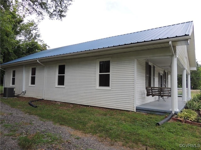 view of property exterior featuring covered porch and central air condition unit