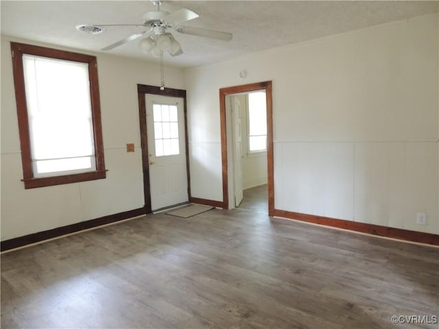 interior space featuring ceiling fan and dark hardwood / wood-style floors