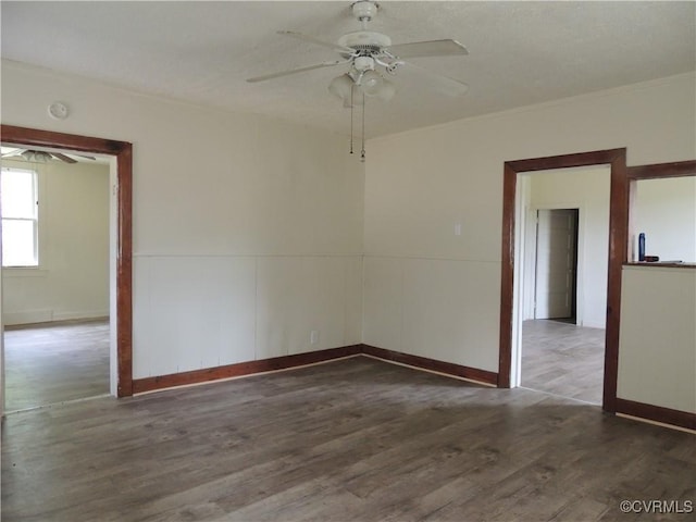 spare room with ceiling fan and dark hardwood / wood-style flooring