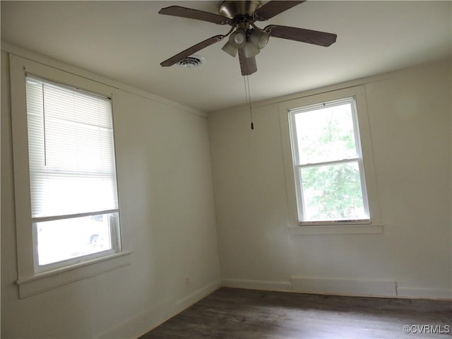 spare room with ceiling fan and dark wood-type flooring