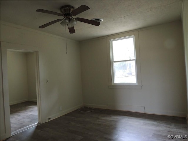 unfurnished room with ceiling fan and dark hardwood / wood-style flooring