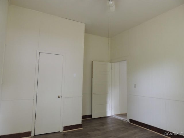 unfurnished bedroom featuring dark hardwood / wood-style flooring