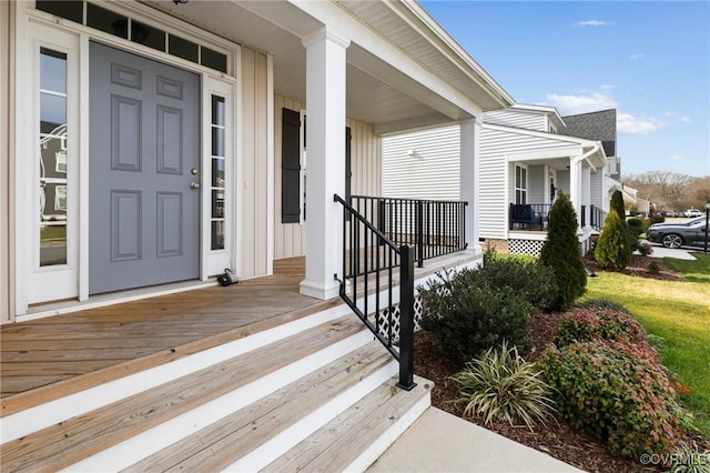 view of exterior entry with a porch