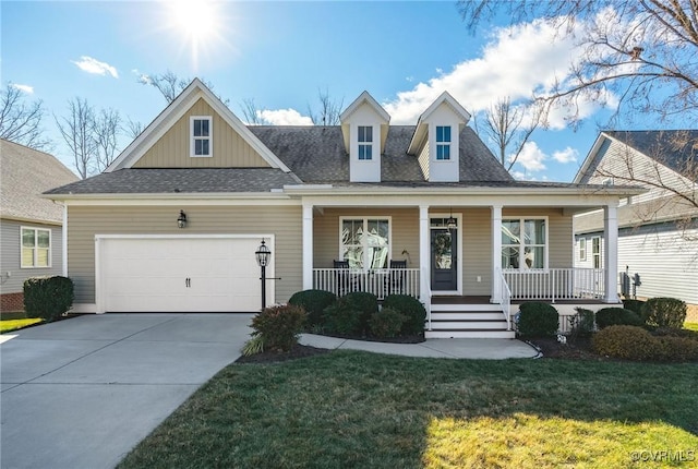 view of front of home with a front lawn, a porch, and a garage