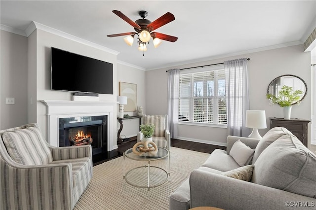 living room featuring ceiling fan, ornamental molding, and hardwood / wood-style flooring