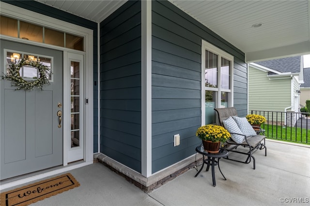 view of exterior entry featuring covered porch