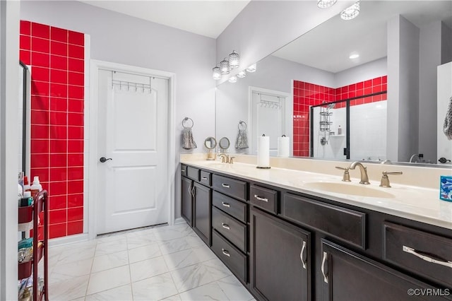 bathroom with a shower with door and vanity