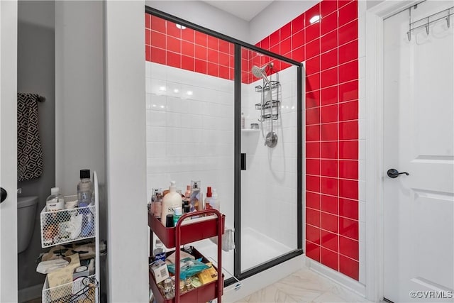 bathroom featuring toilet and an enclosed shower