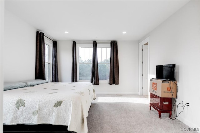 bedroom featuring light carpet