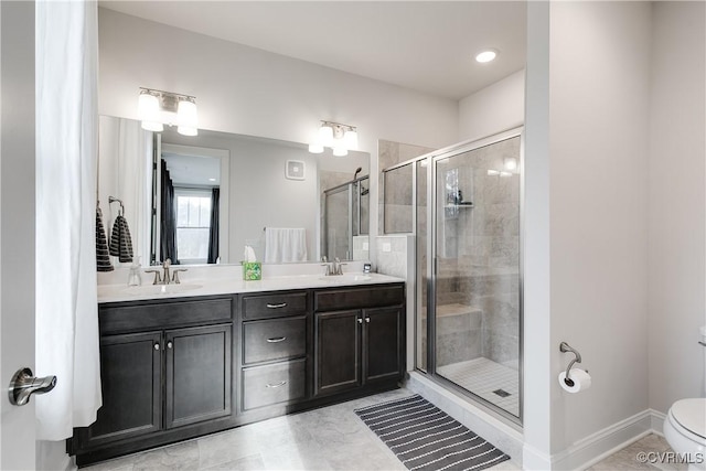 bathroom with tile patterned flooring, a shower with door, vanity, and toilet