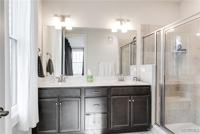 bathroom featuring vanity and a shower with shower door