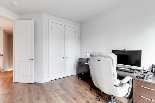 office area with light hardwood / wood-style floors