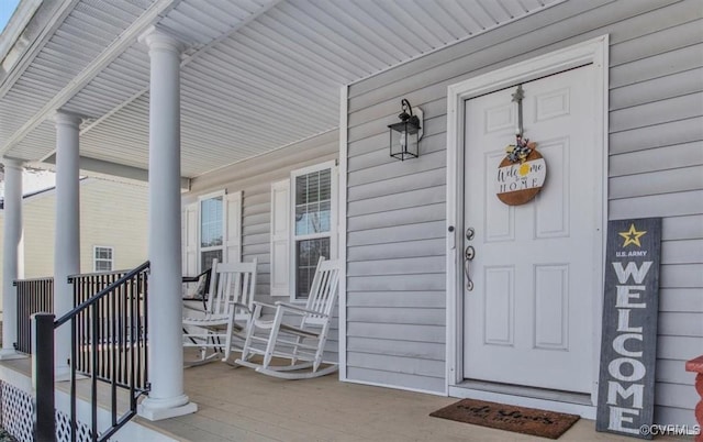 view of exterior entry with covered porch