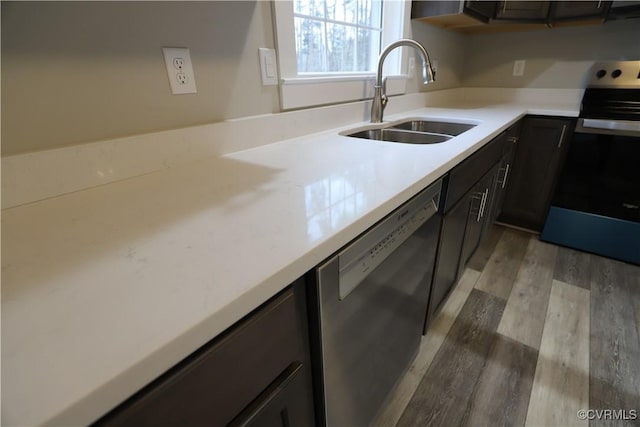 kitchen featuring light wood-type flooring, stainless steel appliances, and sink