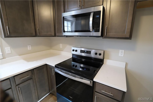 kitchen featuring appliances with stainless steel finishes and dark brown cabinetry