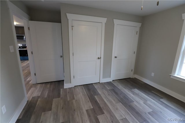 unfurnished bedroom featuring wood-type flooring