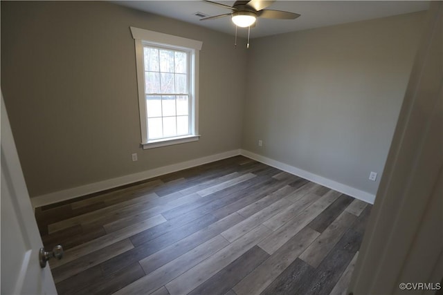 empty room with ceiling fan and dark wood-type flooring