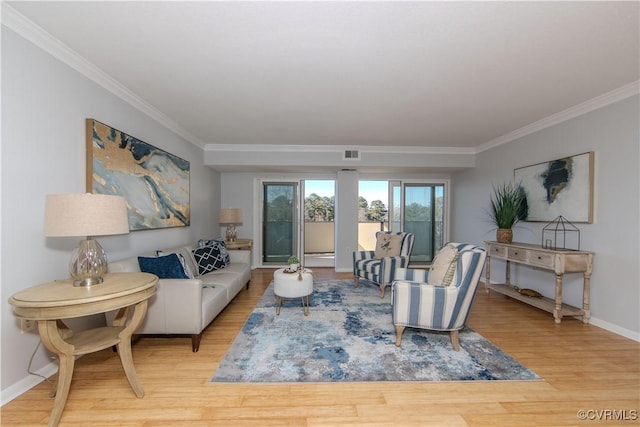 living room featuring french doors, light hardwood / wood-style flooring, and ornamental molding