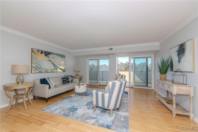 living room with light wood-type flooring and ornamental molding