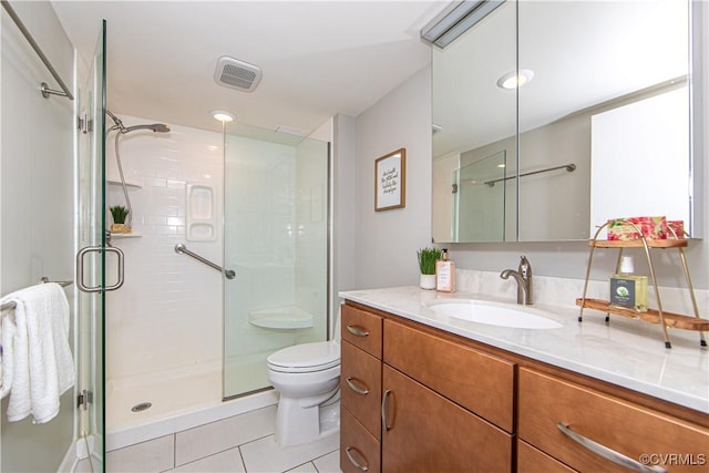 bathroom with tile patterned flooring, vanity, toilet, and an enclosed shower