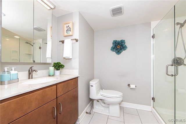 bathroom featuring tile patterned floors, vanity, toilet, and an enclosed shower