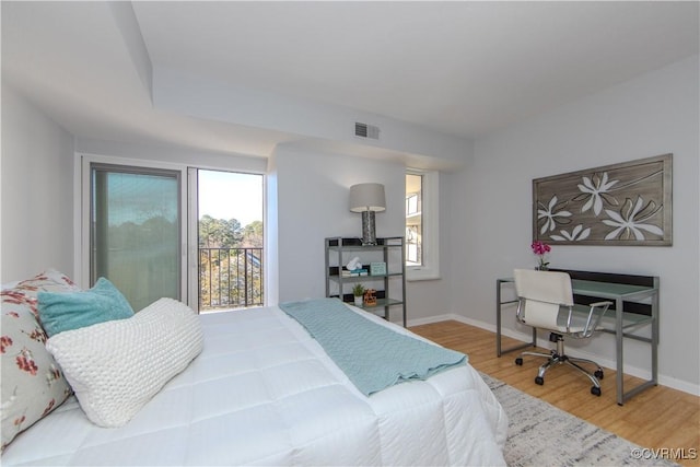 bedroom featuring access to outside and hardwood / wood-style flooring