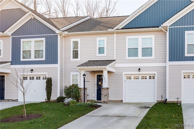 multi unit property with a garage and a front lawn