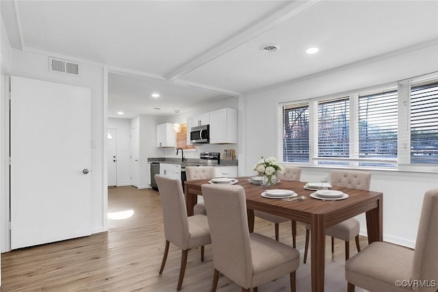 dining room featuring light wood-type flooring and sink