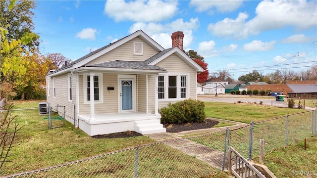 bungalow-style home featuring cooling unit, a porch, and a front lawn