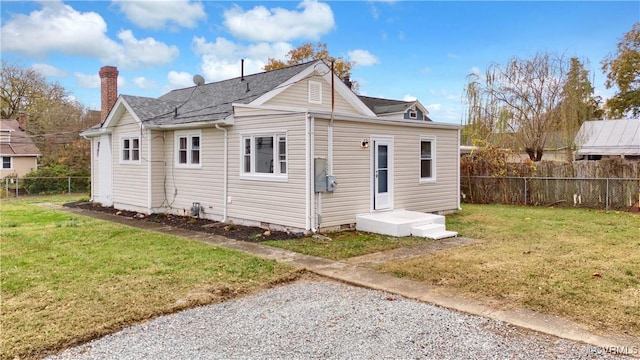 rear view of house with a yard