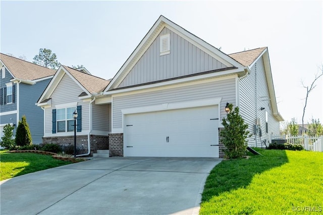 view of front of house featuring a garage and a front lawn