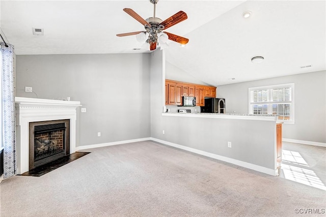 unfurnished living room featuring carpet, ceiling fan, and vaulted ceiling