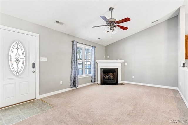 unfurnished living room with ceiling fan, carpet, and lofted ceiling