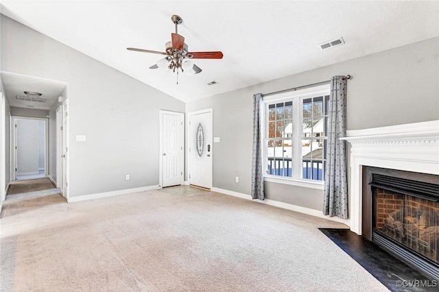 unfurnished living room with ceiling fan, dark carpet, and vaulted ceiling