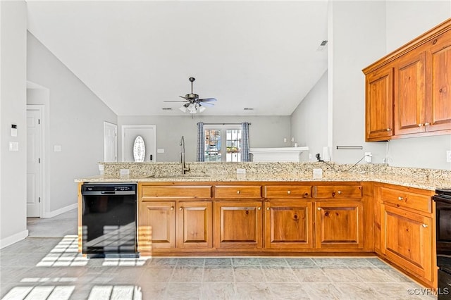 kitchen with sink, light stone counters, ceiling fan, and black appliances