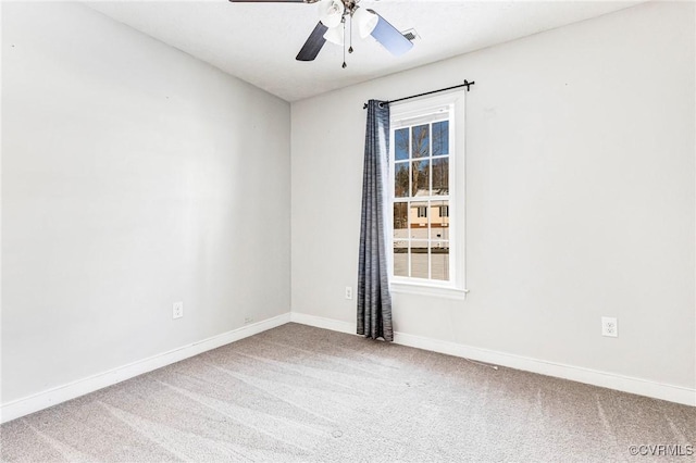 spare room featuring ceiling fan and carpet