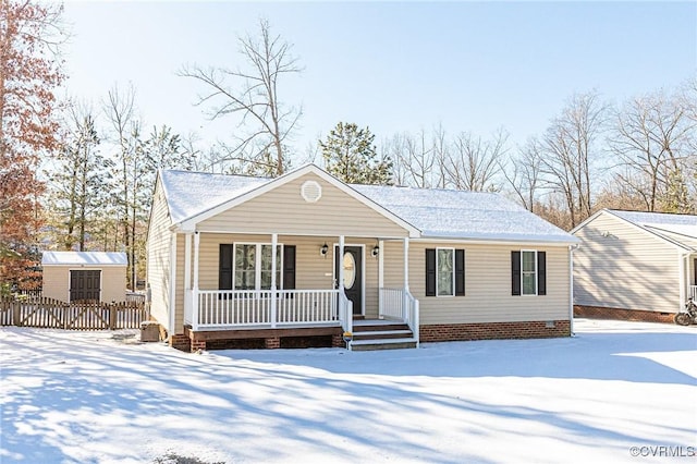 view of front of property featuring a porch and a storage unit