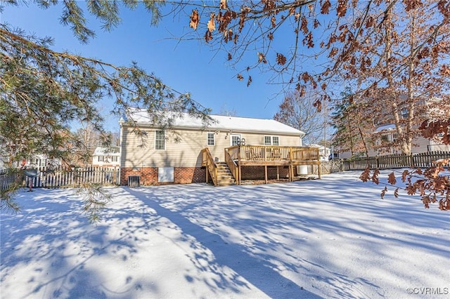 snow covered house with a deck