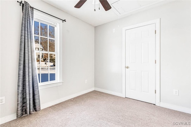 unfurnished room with carpet and ceiling fan