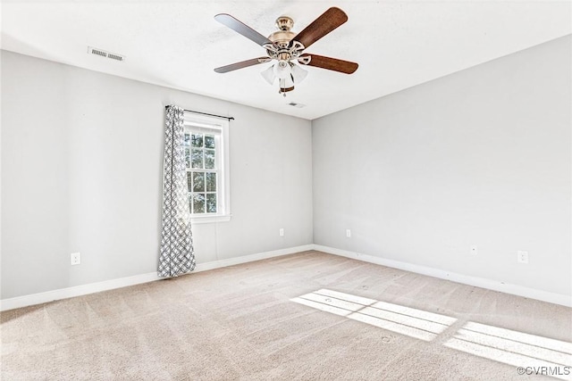 empty room with ceiling fan and carpet floors