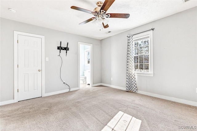 empty room featuring ceiling fan and light colored carpet