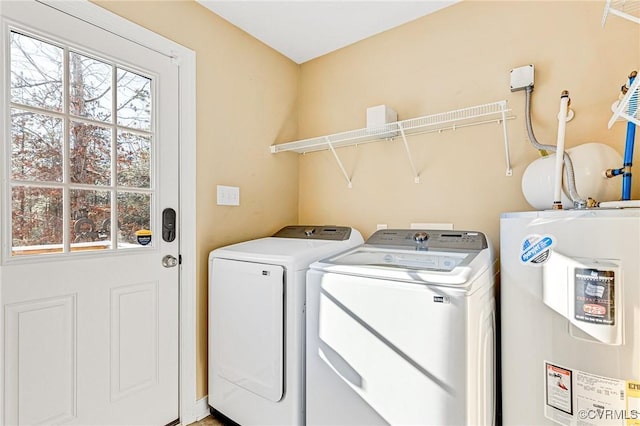 clothes washing area featuring washer and clothes dryer and water heater