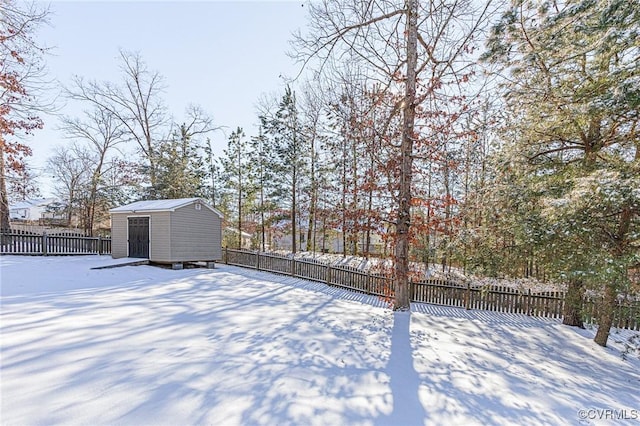 snowy yard with a storage shed