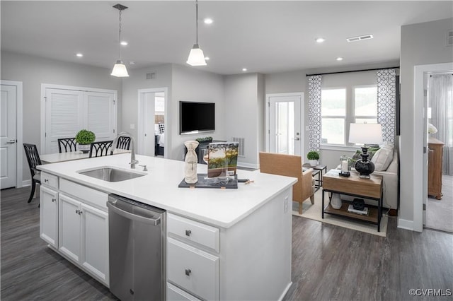 kitchen featuring dishwasher, sink, hanging light fixtures, an island with sink, and white cabinetry