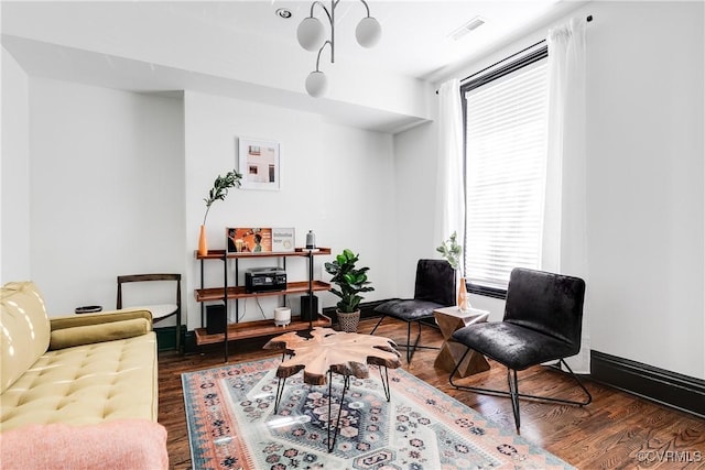 sitting room featuring dark wood-type flooring