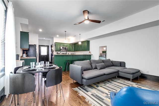 living room with ceiling fan and hardwood / wood-style floors